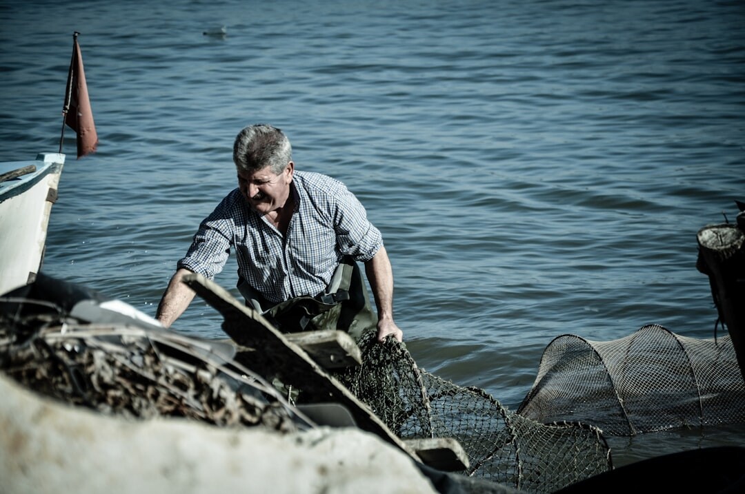 Elderly Danish fisherman portrait mending nets